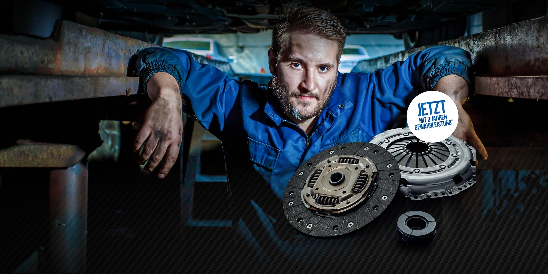 Ein Mechaniker in der Werkstattgrube mit einer SACHS Kupplung.