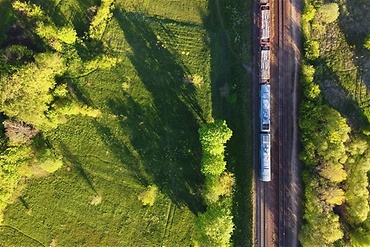 train driving through a green landscape