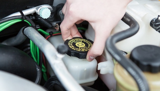 Remove filler cap from compensating reservoir