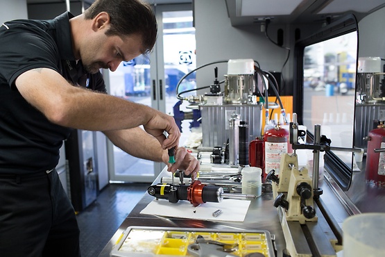 Man in workshop repairing a tool