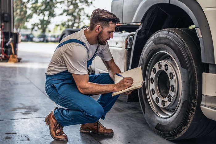 Engineer writing on a Notepad.