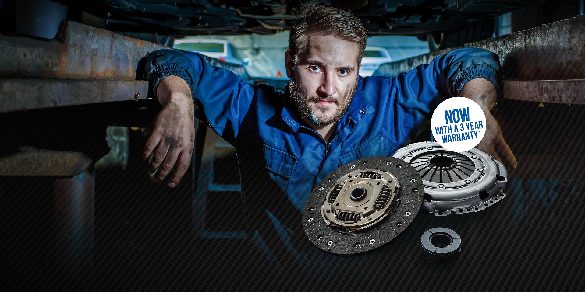 A mechanic standing under a ramp, with SACHS clutch.